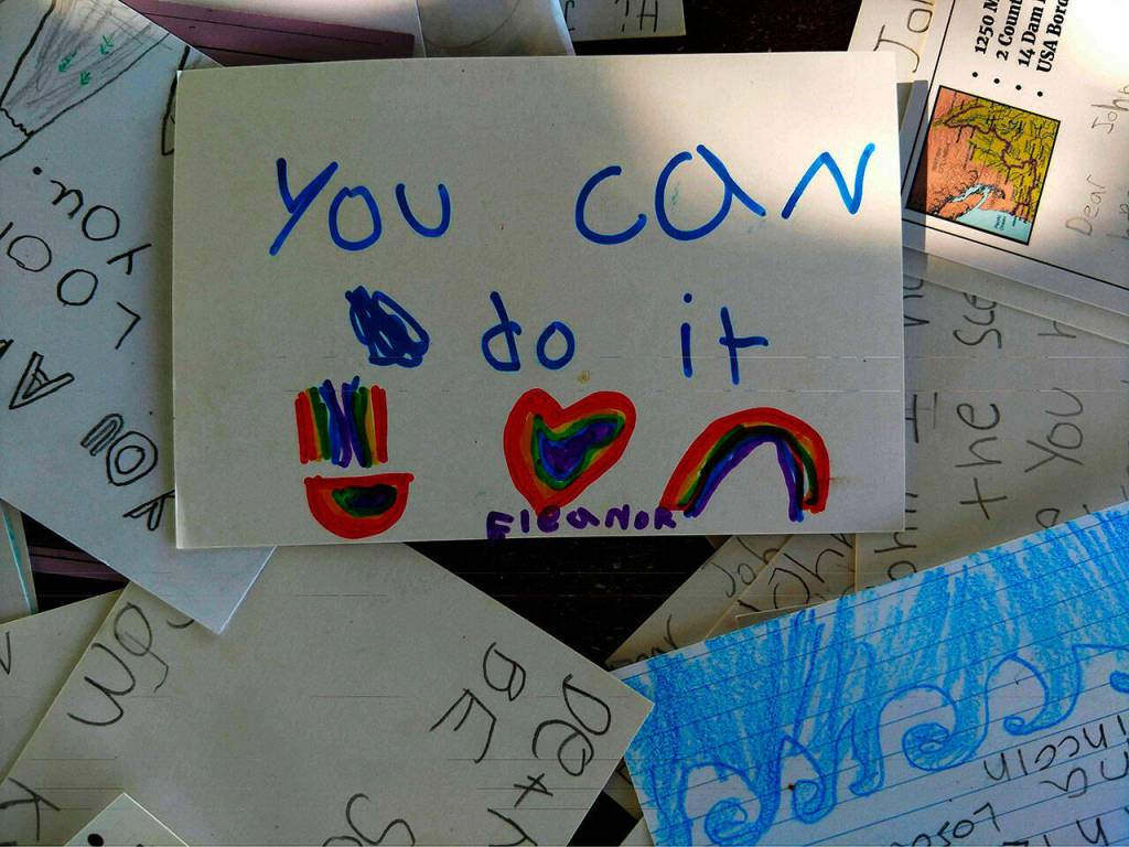 Student writings provide kayaker John Kunts some inspiration as he completes a 1,250-mile journey on the Columbia River. Photo courtesy of John Kuntz