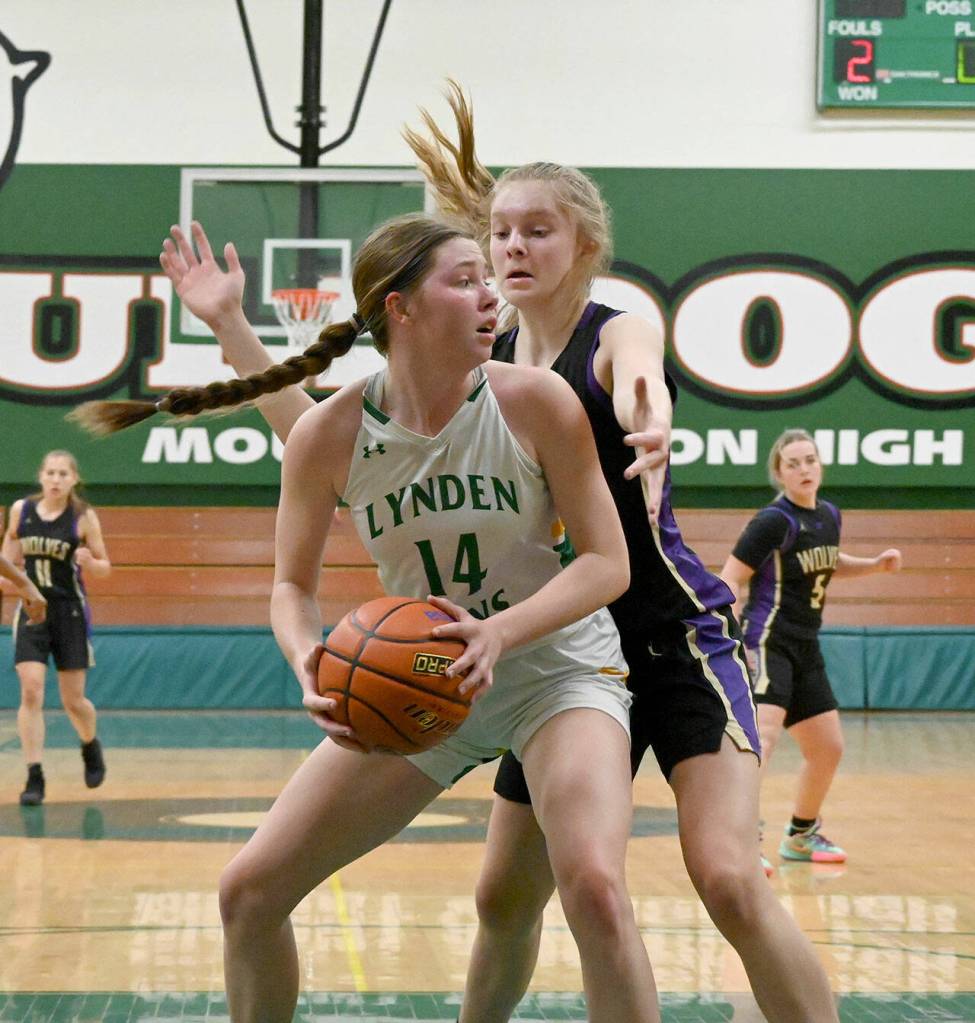 Sequims Jolene Vaara, right, looks to take the ball from Lyndens Haylee Koetje in the first half of the Wolves 50-26 loss in a state regional playoff game on Feb. 25 in Mount Vernon. Sequim Gazette photo by Michael Dashiell