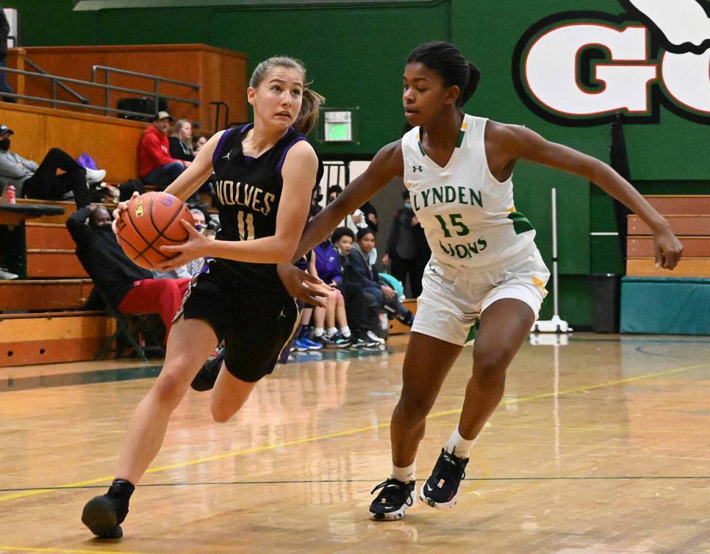 Sequim Gazette photo by Michael Dashiell 
Sequim guard Taryn Johnson, left, drives to the basket as Lyndens Kiki York guards the play in a regional state playoff game in Mount Vernon last week. Lynden prevailed, 50-26.