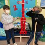 Third-graders Isaac Malkasian and Neala Gallauher, students in Emily Ellefsons class at Helen Haller Elementary School, build a tower using 22 cups as part of their Twosday celebration. Submitted photo