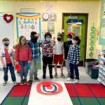 Submitted photo
Helen Haller Elementary students (from left) Aiden Fazio, Bristol Bury, Jalen Williams, Manuel Yanez, Walter Thomas, Kyrie Marchbanks and Isaac Malkasian wait to try their hand at curling. Their class recently learned about the Winter Olympics.