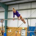 Sequim High senior Alex Schmadeke competes on the uneven bars event at an Olympic League meet on Jan. 19 in Port Angeles. She placed 15th in the event at the state meet. Sequim Gazette photo by Emily Matthiessen