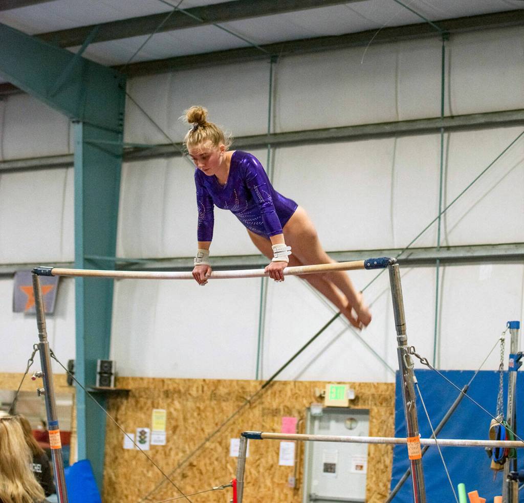 Sequim High senior Alex Schmadeke competes on the uneven bars event at an Olympic League meet on Jan. 19 in Port Angeles. She placed 15th in the event at the state meet. Sequim Gazette photo by Emily Matthiessen
