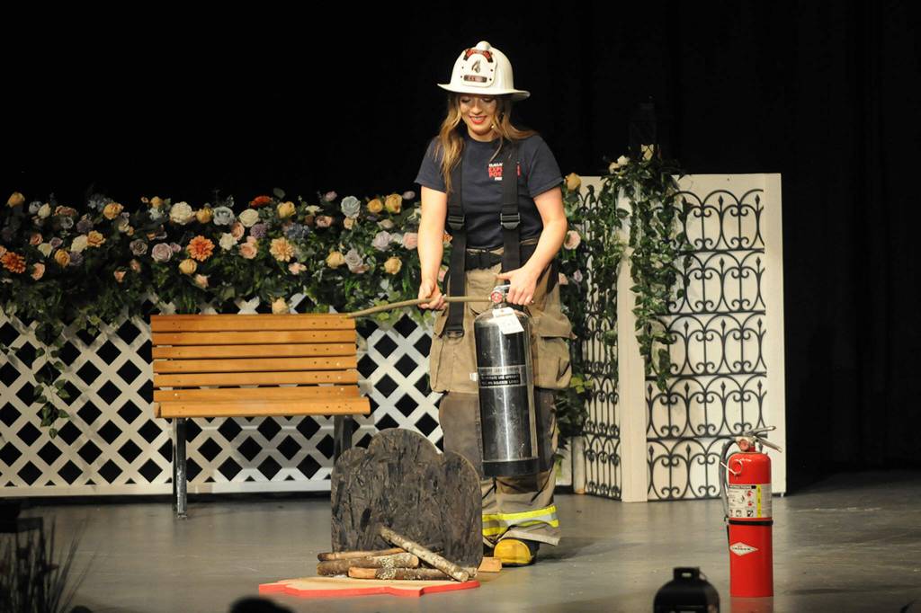 Sequim Gazette photo by Matthew Nash Ellie Turner shares how to safely operate a fire extinguisher during the Scholarship Pageant on Feb. 26.