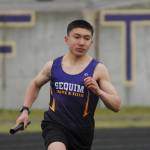 Sequims Koda Robinson competes in the 4x400 relay in the Wolves season-opening meet against Olympic in March 2021. Sequim Gazette file photo by Michael Dashiell