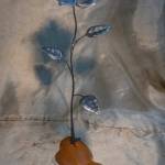 This metal flower sculpture on a wooden base was designed and made by Clallam County Gem & Mineral Association member Chuck Hagood, and is one of the items up for raffle at the clubs annual show later this month in Port Angeles. Submitted photo