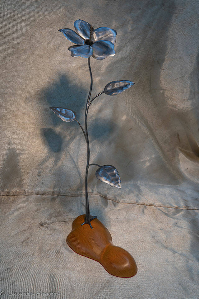 This metal flower sculpture on a wooden base was designed and made by Clallam County Gem & Mineral Association member Chuck Hagood, and is one of the items up for raffle at the clubs annual show later this month in Port Angeles. Submitted photo