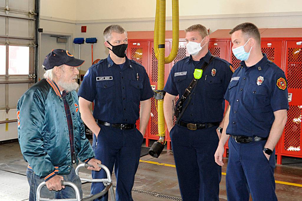 Sequim Gazette photo by Matthew Nash
Gregg Vella chats with with Clallam County Fire District 3 firefighters Capt. Kjel Skov, firefighter/paramedic Mark Mullvain, and Capt. Joel McKeen on March 1 about his Feb. 13 rescue from his house fire. Skov and Mullvain went into the burning house to pull Vella out while McKeen and Clallam County Sheriff deputy Steffen Estep brought him outside.