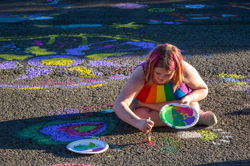 Sequim Gazette photo by Emily Matthiessen
Looking like a rainbow herself, Ruth Korwel, 11, spreads colorful cheer on the asphalt of Carrie Blake Community Park as part of the Community Art Street Painting Project.