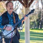 Tom Shindler sings and plays the banjo at the Gazebo in Carrie Blake Community Park for the enjoyment of Sequim Sunshine Festival participants on Saturday afternoon. Shindler played the guitar too, performing a series of sun-related songs for his solo set. Sequim Gazette photo by Emily Matthiessen