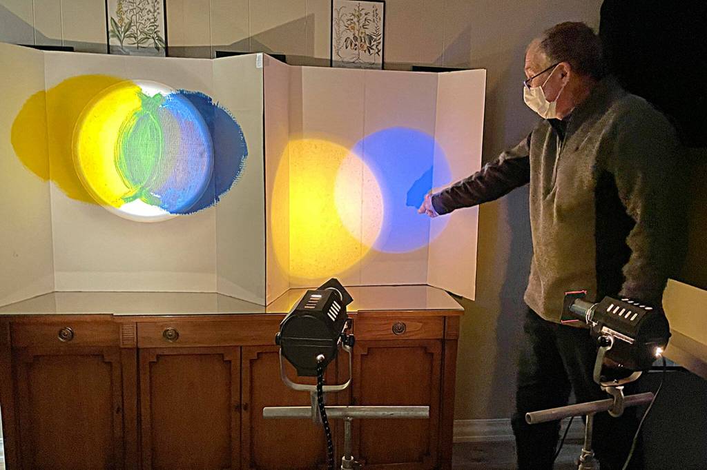 Sequim Gazette photo by Matthew Nash
Artist Ross Brown shows in his Interactive Light Experience how light influences additive color mixing, such as with blue and yellow making white rather than green with paint.
