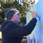 Sequim artist Craig Robinson refreshes this mural, updating it from last years message of Be the i in Sequim to Spectacular Sequim at Carrie Blake Community Park on March 5, as part of the 2022 Sequim Sunshine Festival. Sequim Gazette photo by Michael Dashiell