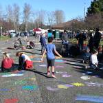 Youngsters and adults alike enjoy the Community Street Mural Art Project at Carrie Blake Park on March 5, part of the 2022 Sequim Sunshine Festival. Sequim Gazette photo by Michael Dashiell