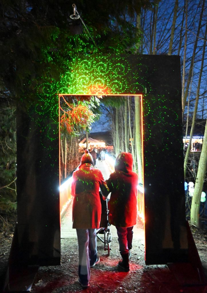 Sequim Gazette photo by Michael Dashiell
Attendees of the 2022 Sequim Sunshine Festival enjoy a colorful light display on a bridge at Carrie Blake Community Park on March 5, courtesy of light artist Ross Brown.