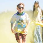 Owen DeAngelo grins as he gets a touch of yellow at the last color station at the Sun Fun Color Run 5k Saturday morning at the Albert Haller Playfields just north of Carrie Blake Community Park. More than 500 participants were registered to run/walk 5k and 1k race. Sequim Gazette photo by Michael Dashiell