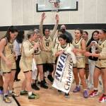 Keith Thorpe/Peninsula Daily News
Members of the Peninsula College womens basketball team celebrate Wednesday's 67-61 win over Shoreline to earn them the NWAC North Region championship. Holding the banner was Ariyanna Camacho-Villafuerte.