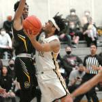 Peninsulas Roosevelt Williams Jr., right, takes aim at the net while defended by Shorelines Jalyn Stepney on March 9 at Peninsula College.