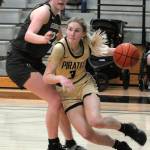 Photo by Keith Thorpe/Olympic Peninsula News Group
Peninsulas Millie Long, right, drives past the defense of Shorelines Symone Pease during a March 9 season finale in Port Angeles.