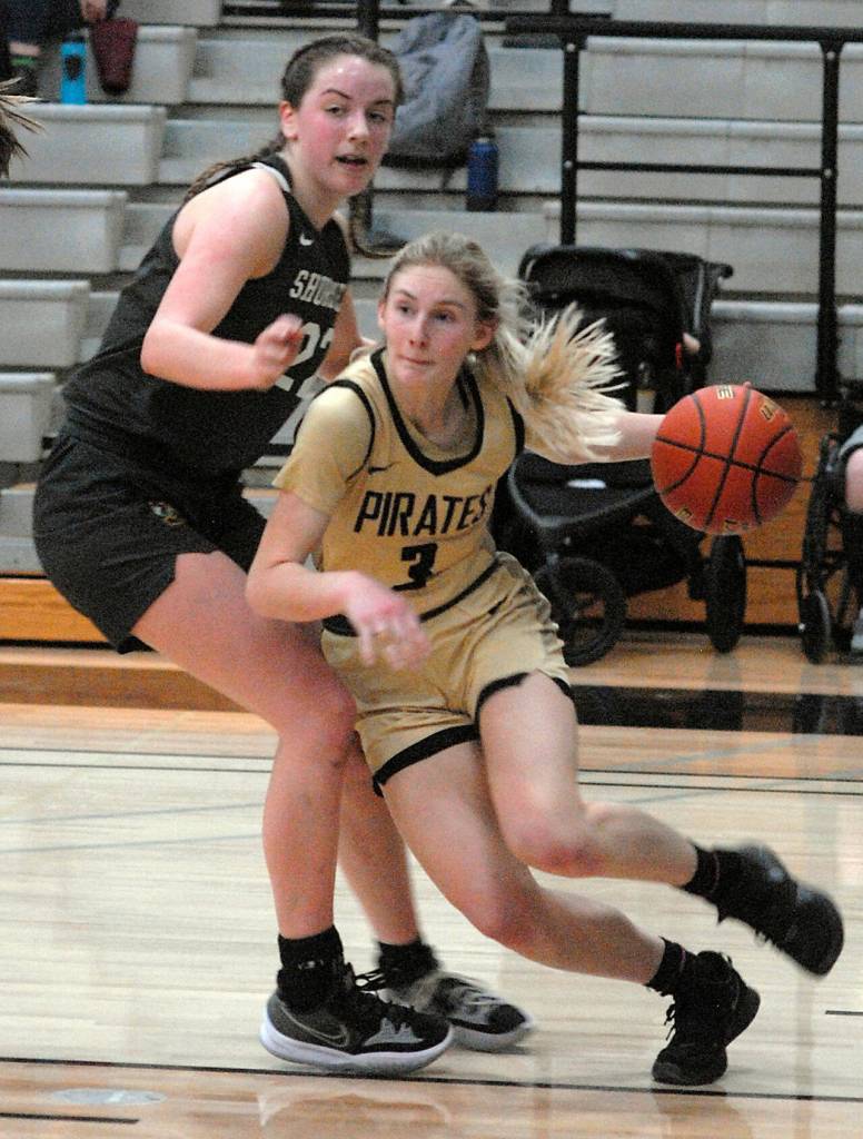 Photo by Keith Thorpe/Olympic Peninsula News Group
Peninsulas Millie Long, right, drives past the defense of Shorelines Symone Pease during a March 9 season finale in Port Angeles.