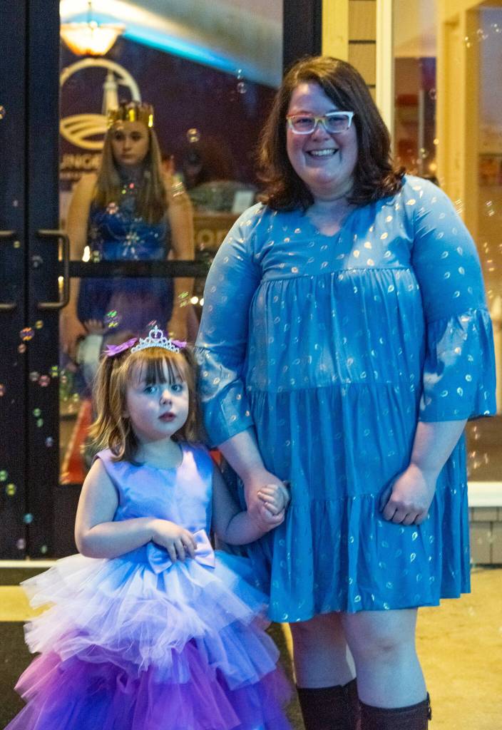 Johanna Aksamit, three, and her mother, Megan, pause for a picture in the bubbles outside of Sequims Dungeness Community Church on March 11, on their way to attend the Toddler Prom. Aksamit said she has a new baby at home and she wanted to do something special with her older daughter. (Its) something we can do together. Sequim Gazette photo by Emily Matthiessen