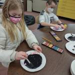 Madison Bell and Xavier Devlin create scratch paper art in Heather Rileys class at Helen Haller Elementary School.