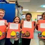 From left, Helen Haller Elementary School students Aidan Walsh, Ridley Bruni, Valentino Kompkoff display their descriptive paragraphs.