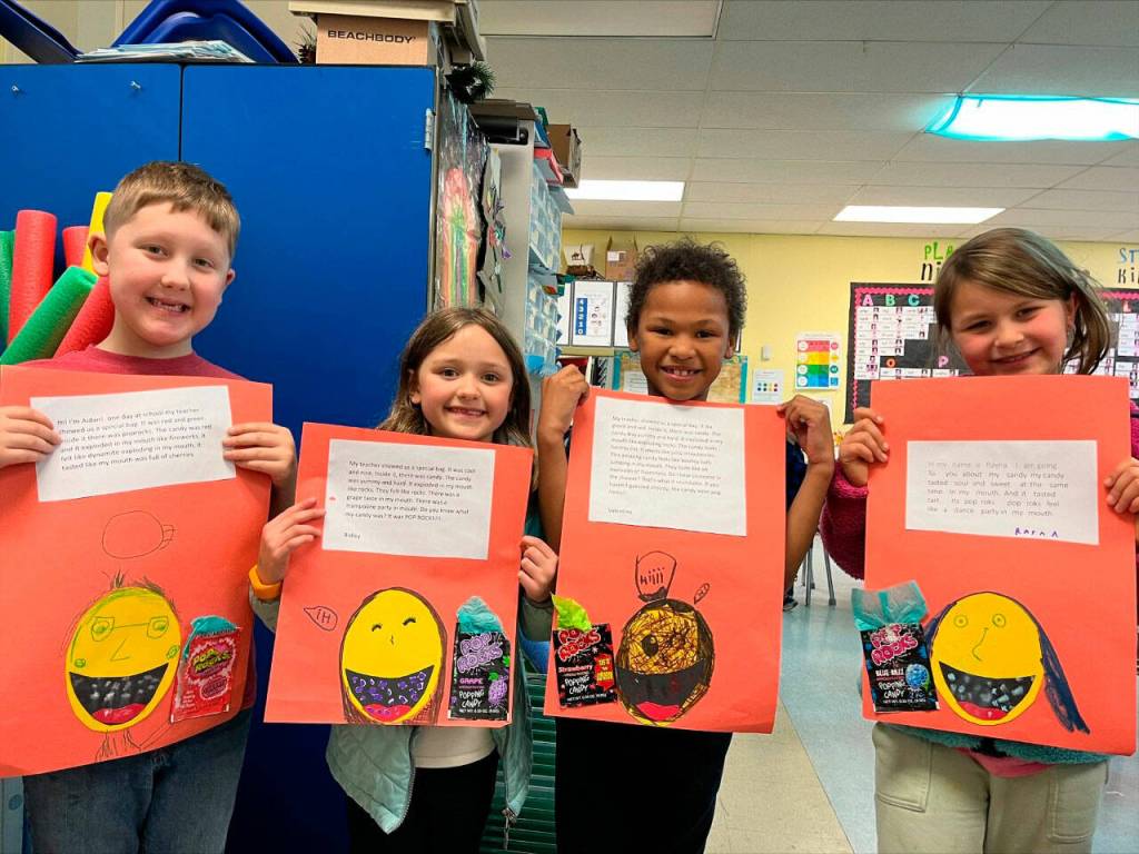 From left, Helen Haller Elementary School students Aidan Walsh, Ridley Bruni, Valentino Kompkoff display their descriptive paragraphs.