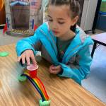 Laina Bo, a third-grader at Helen Haller Elementary, works on her rainbow bridge.