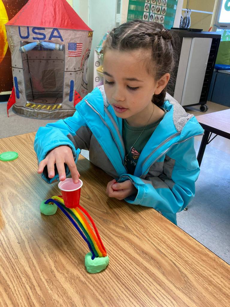 Laina Bo, a third-grader at Helen Haller Elementary, works on her rainbow bridge.