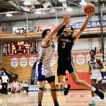 Peninsulas Jaylin Reed, right, looks to drive past Lanes Ethan Blythe to the basket in an NWAC tournament first round game in Everett in March 17. Reed had 20 points in Peninsulas 82-68 loss to the top-seeded Titans. Photo by Jay Cline/Peninsula College