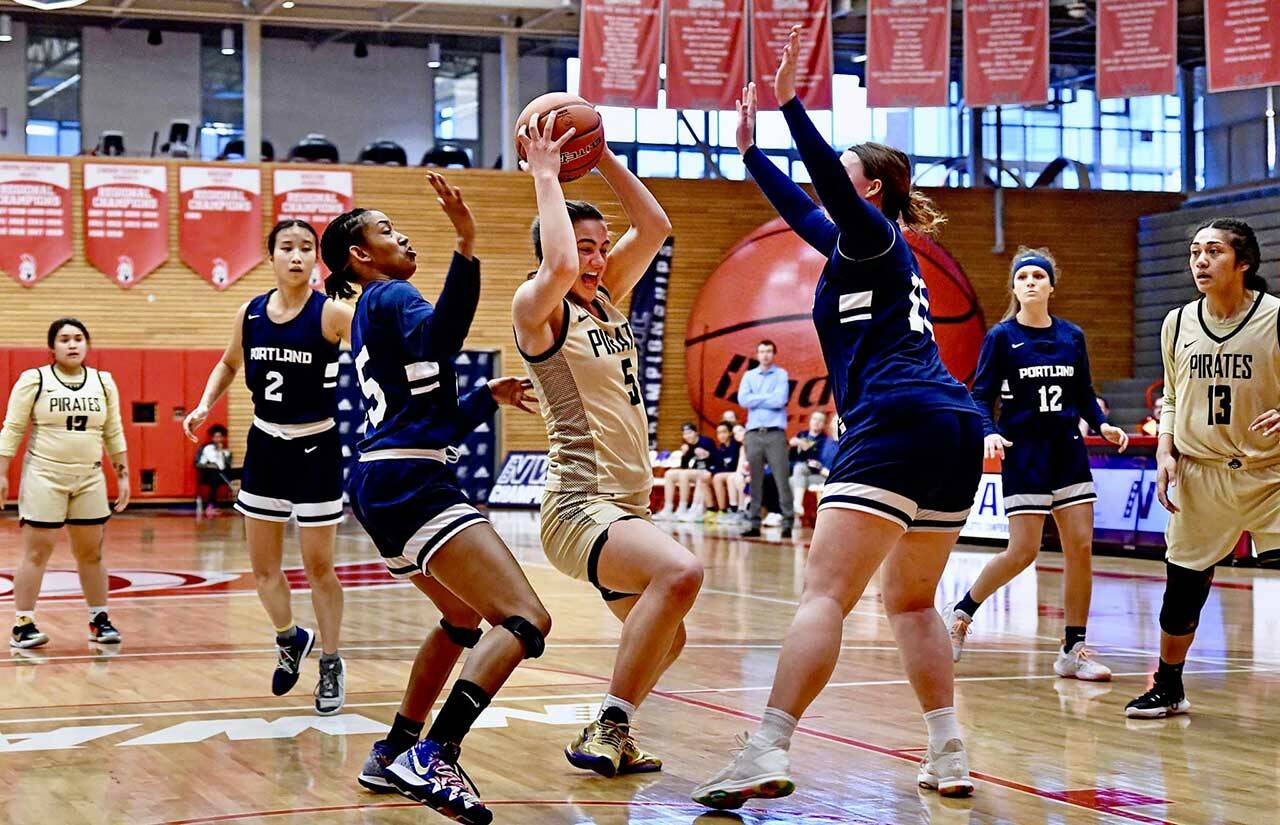 Peninsulas Hope Glasser, center, controls possession as Portland defenders Nia Bradley, left, and Iris Cubit defend the play, in a 64-59 Peninsula win in Everett on March 20. Glasser, a Sequim native, had 15 points and six rebounds as Peninsula earned a Final Four berth.