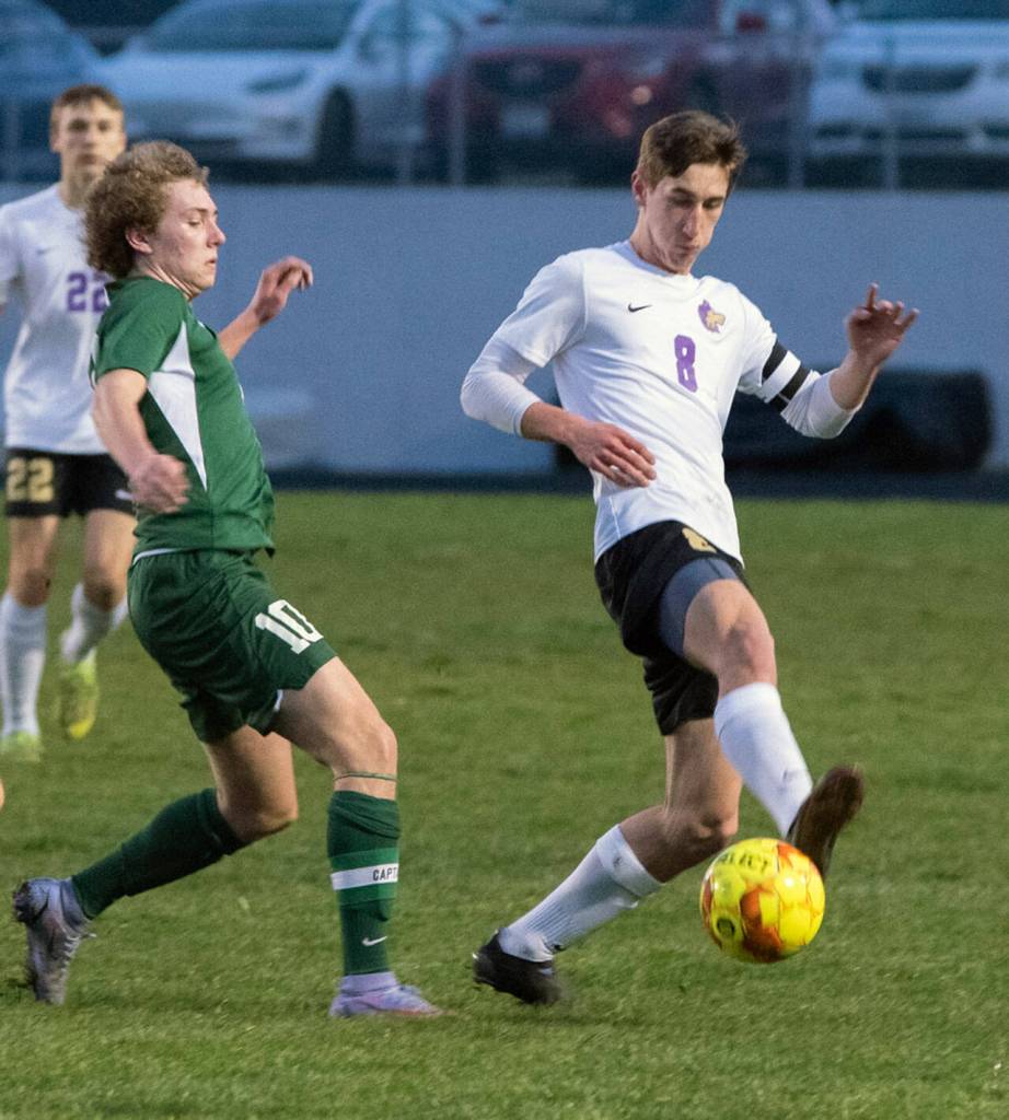 Sequims Brandon Wagner, right, keeps possession from Port Angeles Damon Gunderson as the Wolves blank the visiting Roughriders 5-0 in March 17. Sequim Gazette photo by Emily Matthiessen