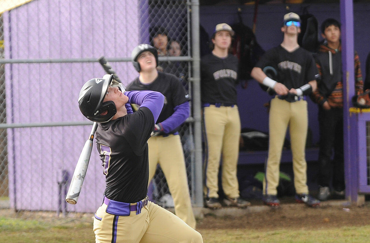 As teammates look on, Sequims Conor Bear skies a popup in the first inning of the Wolves league opener against Bainbridge in March 15. The Wolves took an early 2-0 lad but fell to the 3A Spartans, 22-22. Sequim also dropped a 22-2 game at league foe Bremerton on March 17 and a 10-0 decision to 1A Forks on March 18. Sequim (0-3) was slated to host North Kitsap on March 22; results were not available at press time. The Wolves are at North Mason on March 24 and at Anacortes on March 26 before hosting Kingston on March 28. Sequim Gazette photo by Michael Dashiell