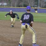 Sequim second baseman Marshall Phipps gathers up a grounder and throws to first baseman Zac McCracken to throw out a Bainbridge runner in a March 15 Olympic League game. Sequim Gazette photo by Michael Dashiell