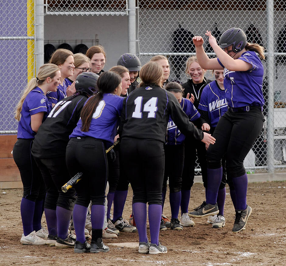 Sequim Gazette photos by Michael Dashiell
Above: Sequim teammates celebrate Amelia Pozernicks home run in the Wolves 12-0 rout of visiting 1A Forks on March 18. 
Right: Sequim pitcher Angel Wagner shuts out the Forks Spartans on March 18, a 12-0 Wolves non-league win