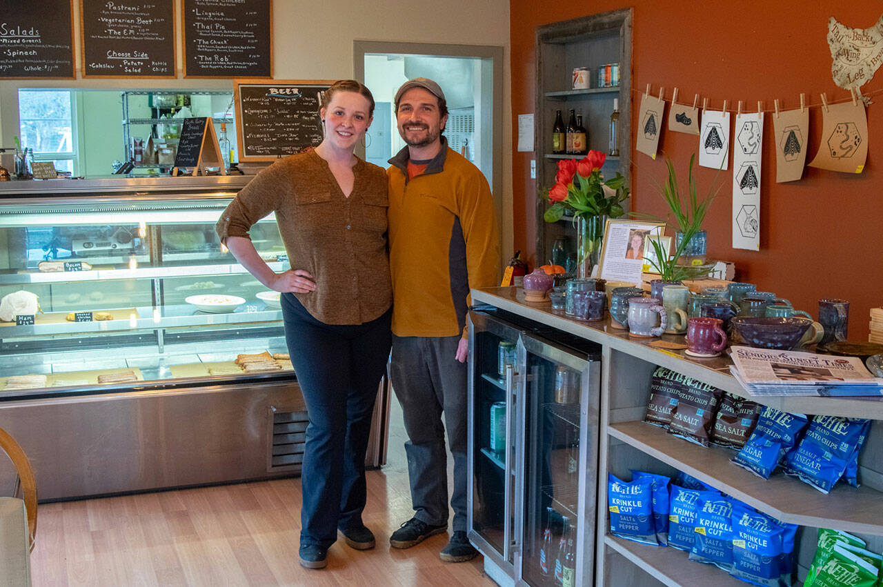 Seven-year employee Stacey Sevier and owner John Pabst look back at eight years of good food and community connections at Pacific Pantry Eatery in Sequim, on the eve of the next phase of the business. To their left is the artwork by Sequims Jaiden Dokken. Sequim Gazette photo by Emily Matthiessen