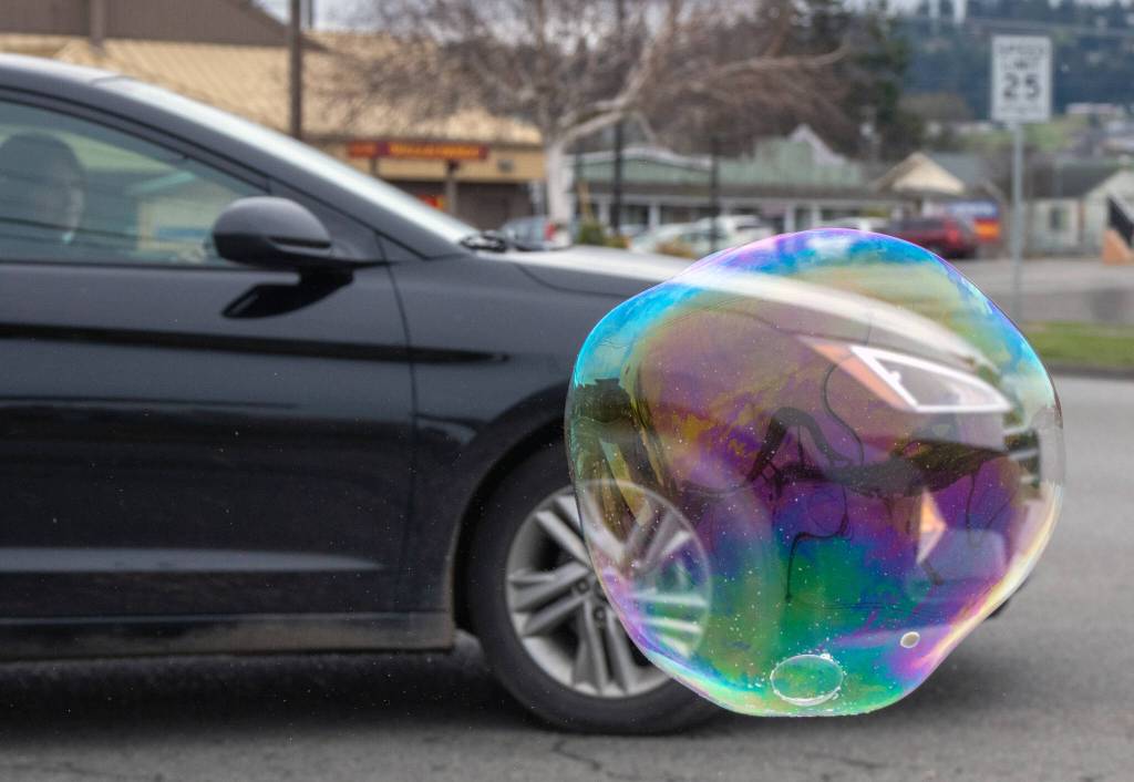 The Davis family produces giant bubbles with homemade bubble solution at the Sequim Safeway plaza on March 21. Sequim Gazette photo by Emily Matthiessen