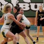 Sequim guard Hannah Bates, center, muscles her way into the lane looking for a basket in the Wolves state regional playoff game against Lynden on Feb. 25. Bates was named to the All-Olympic League first team. Sequim Gazette photo by Michael Dashiell