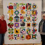 Sequim Gazette photo by Matthew Nash/ Members of the Sunbonnet Sue Quilt Club bring their annual raffle quilt Down on the Farm to the Sequim Museum and Arts on April 1 to start promotions for their annual show set for July 16 in Pioneer Memorial Park. Bonnie Filgo, left, pieced the quilt together, and Marianne Nolte, club president, looks to sell out of raffle tickets before the show.