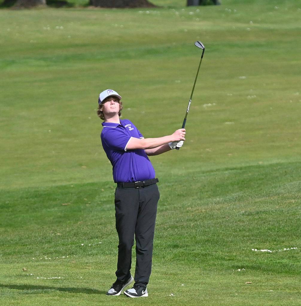 Sequims Ben Sweet hits an approach shot at the first hole of a March 24 match against North Mason at The Cedars at Dungeness. Sequim Gazette photo by Michael Dashiell