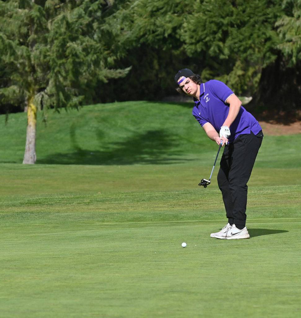 Sequims Lars Wiker lines up a putt on the first hole in a March 24 match against North Mason at The Cedars at Dungeness. Sequim Gazette photo by Michael Dashiell