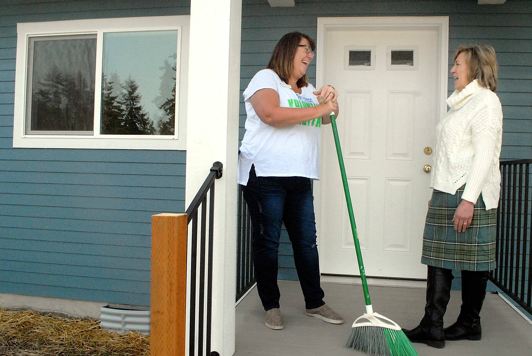 Habitat for Humanity of Clallam County CEO Colleen Robinson, left, talks with Julie Maron, the organization's family resource manager, on the porch of a completed Habitat house on Maloney Court in Port Angeles on March 24. Photo by Keith Thorpe/Olympic Peninsula News Group