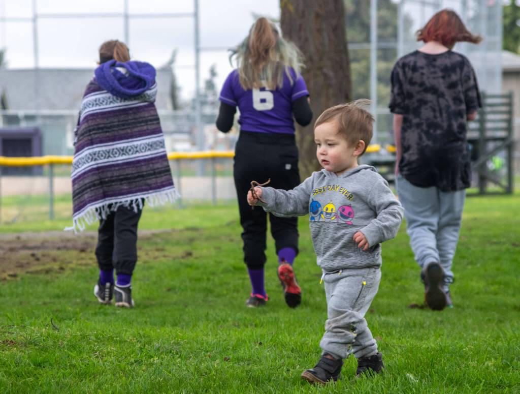 Enjoying opening day of Sequim Little Leagues 2022 season in his own way, Lincoln Ryan Diaz finds a worm to show his father. Sequim Gazette photo by Emily Matthiessen