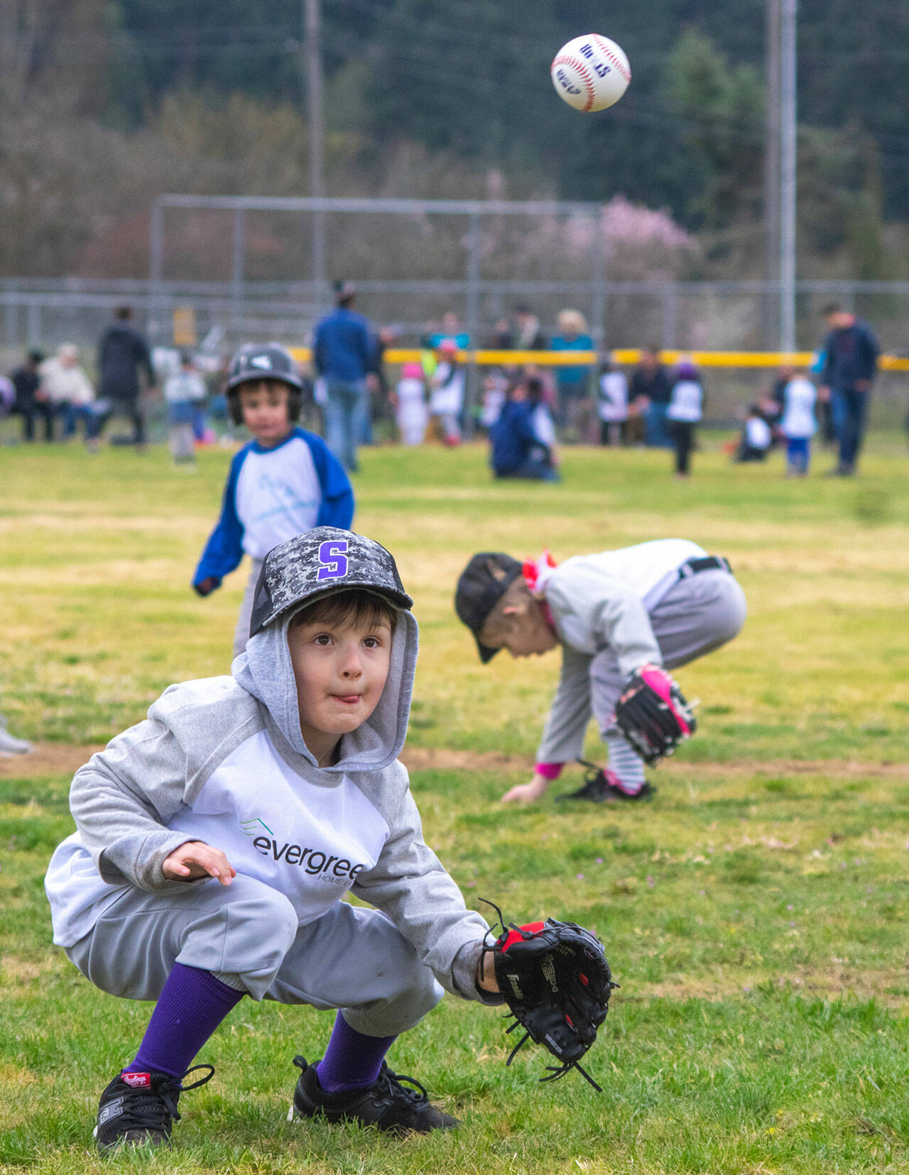 T-Ball player Dominic Johnson tries for a catch during opening day of the 2022 Sequim Little League. Sequim Gazette photo by Emily Matthiessen