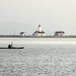 Photo by Keith Thorpe/Olympic Peninsula News Group
Ken Lincoln of Port Townsend kayaks across Dungeness Bay against a backdrop of the New Dungeness Lighthouse on March 26 just north of Sequim. Lincoln said he was paddling out from Cline Spit to meet a group of other kayakers who were putting in at Port Williams.