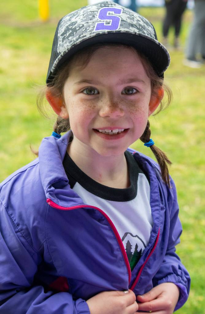 Grace Taylor, 6, participates in the excitement of opening day of Sequim Little League, her first year as a T-Ball player. Sequim Gazette photo by Emily Matthiessen