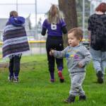 Right: Enjoying opening day of Sequim Little Leagues 2022 season in his own way, Lincoln Ryan Diaz finds a worm to show his father.