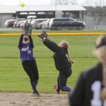 Sequim shortstop Hannah Bates, left, snags an infield pop-up as second baseman Addie Smith backs her up in the Wolves 8-6 loss to North Kitsap on March 29.