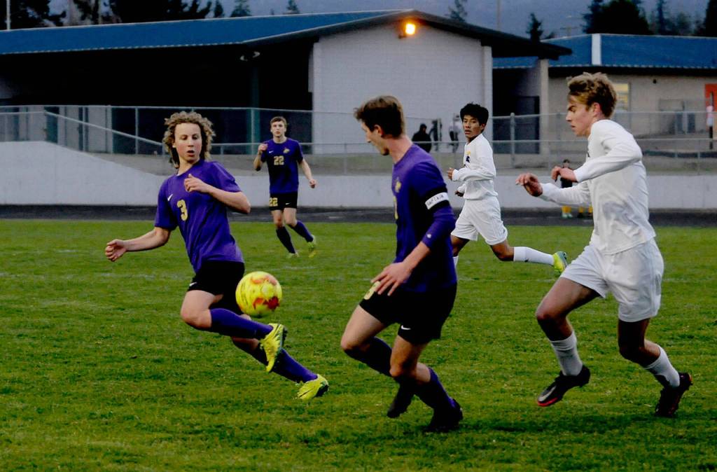 Sequims Cruz Pernia, left, and Brandon Wagner vie for a loose ball in the first half of a 3-0 home loss to Bainbridge on March 29. Sequim Gazette photo by Michael