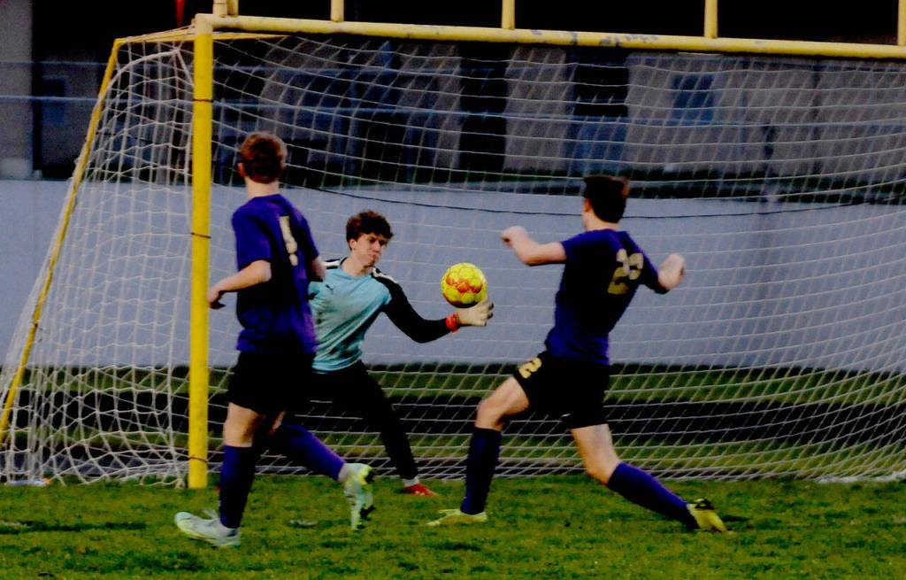 Left: Sequim goalkeeper Jack Van De Wege makes a goal-saving deflection in the first half of the Wolves 3-0 loss to Bainbridge on March 29.